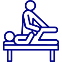 Massage therapist giving a back massage to a client on a massage table in a treatment room.